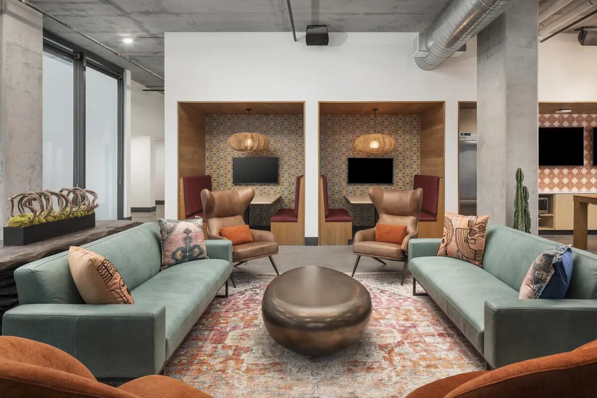 Two sofas, two booths, metal table, lounge area at Atmosphere Tempe in Tempe Student Accommodation