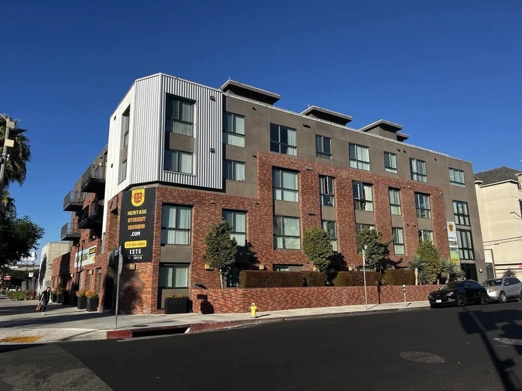 Brick building with signs and balconies exterior at USC Student Housing: Heritage 1275 in Los Angeles Student Accommodation