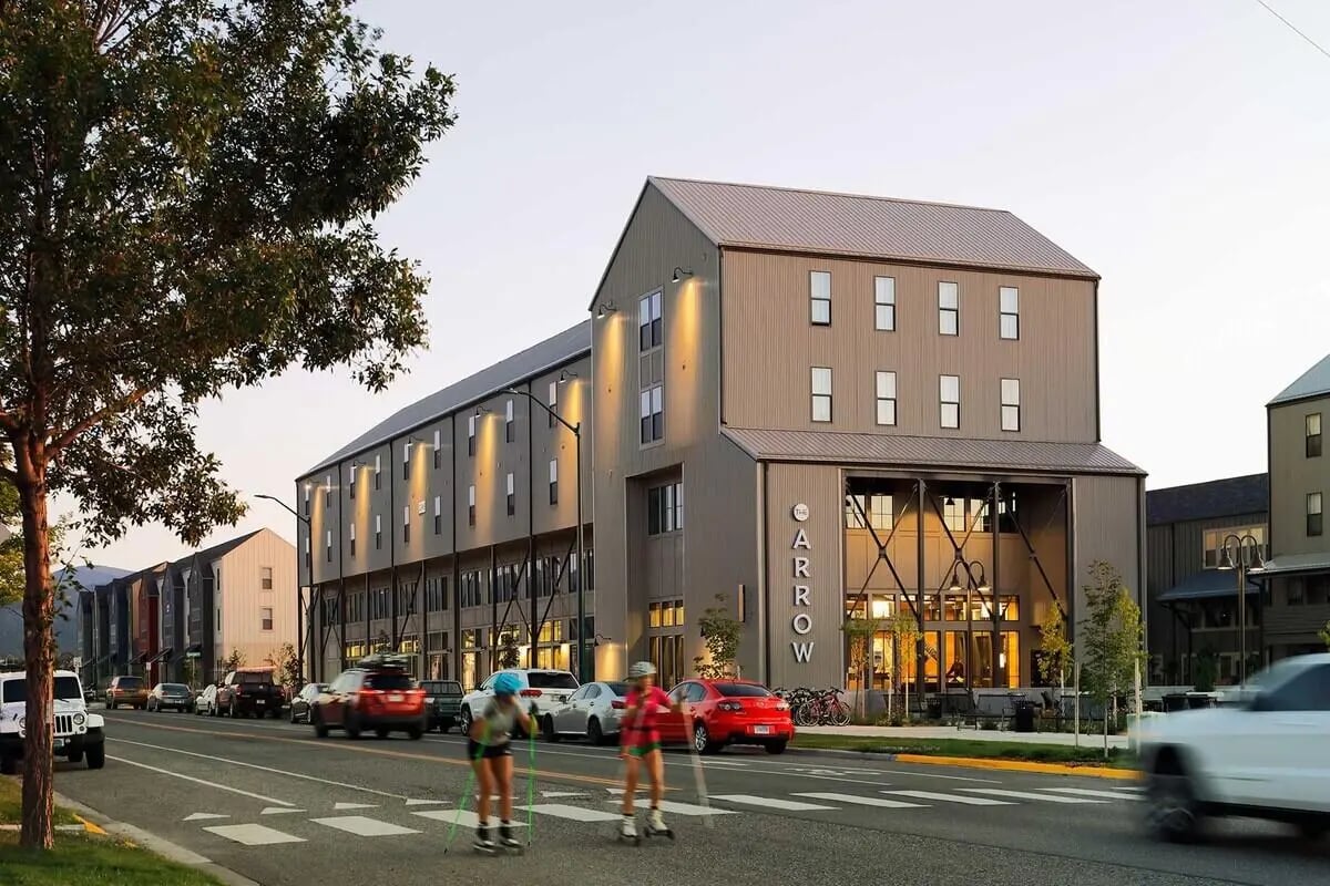 Modern accommodation building cars street exterior. at The Arrow Townhomes & Flats in Bozeman Student Accommodation
