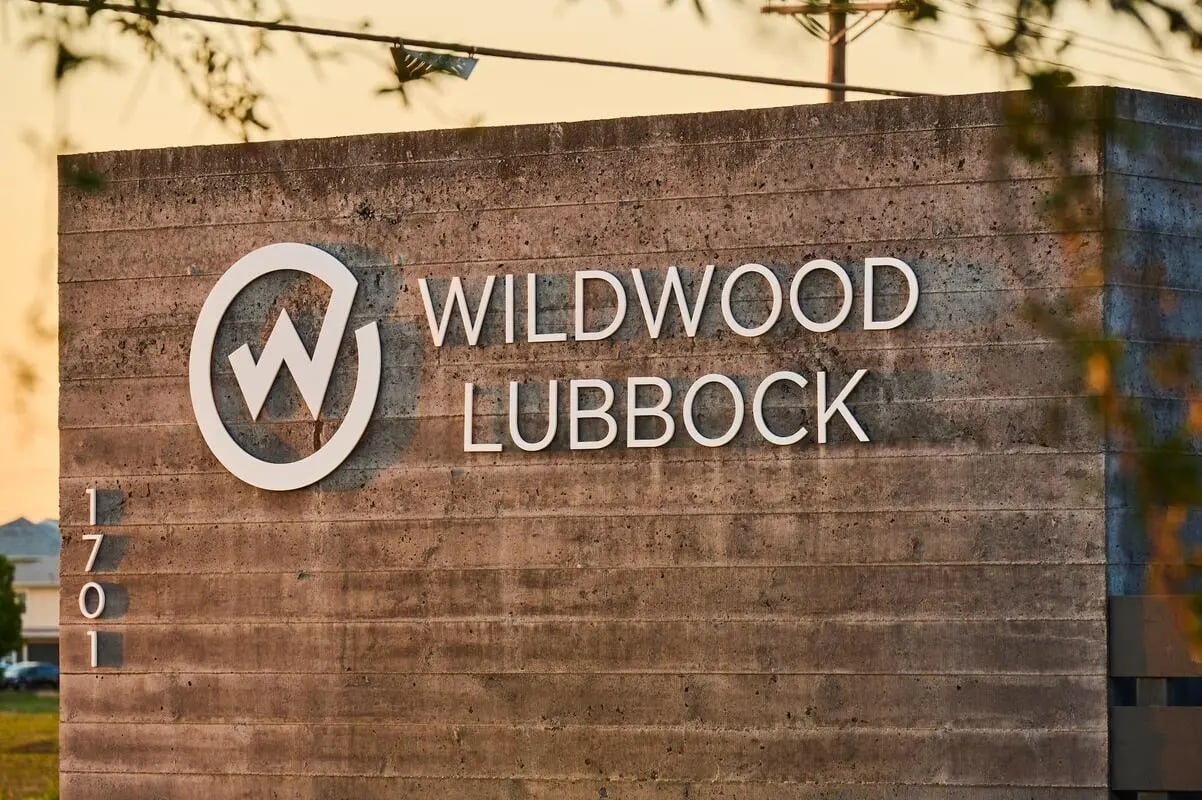 Wildwood Lubbock sign on concrete exterior exterior at Wildwood Lubbock in Lubbock Student Accommodation