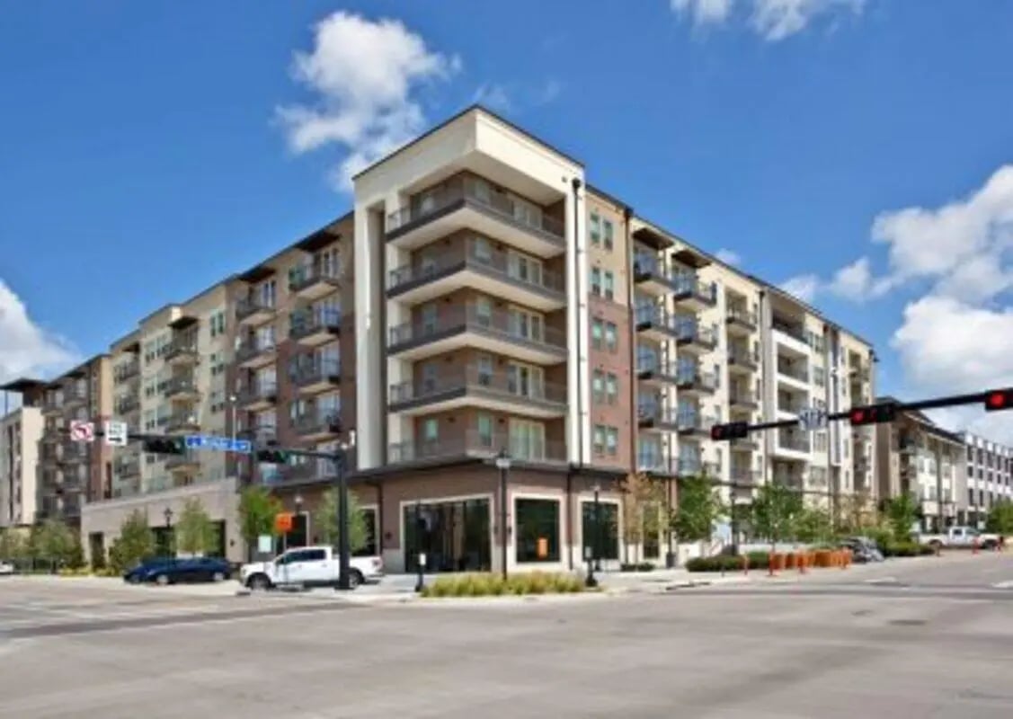 Modern apartment building with balconies and street exterior at 101 Center in Arlington Student Accommodation