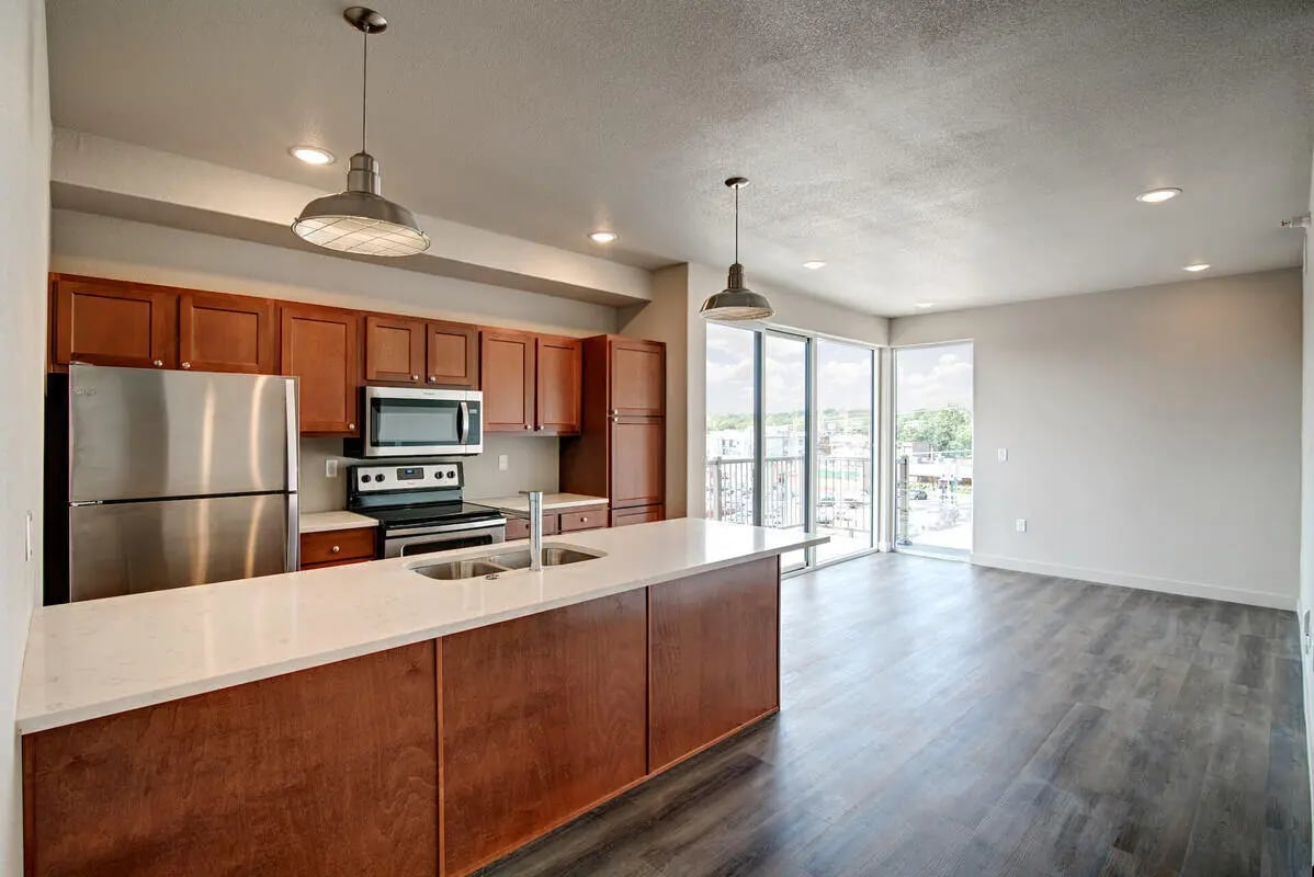 Stainless steel fridge and cabinets kitchen view at 12b Lofts Apartments in Manhattan Student Accommodation