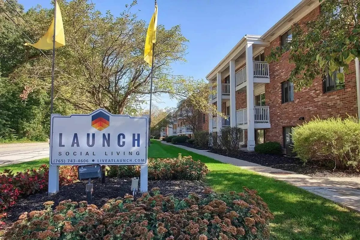 Launch sign and apartment buildings exterior at Launch Apartments in West Lafayette Student Accommodation