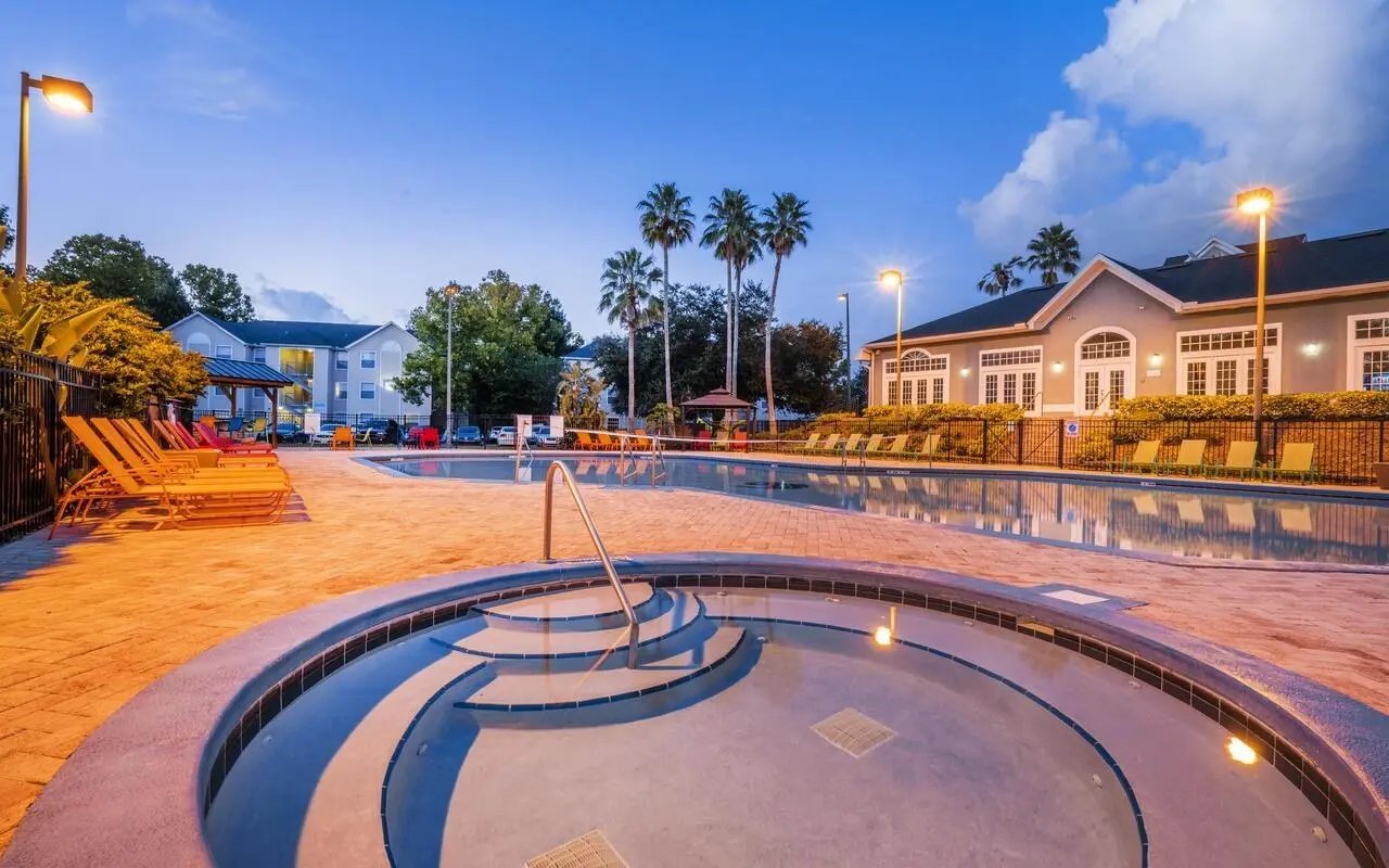 Pool with lounge chairs and jacuzzi exterior at The Pointe at Central in Orlando Student Accommodation