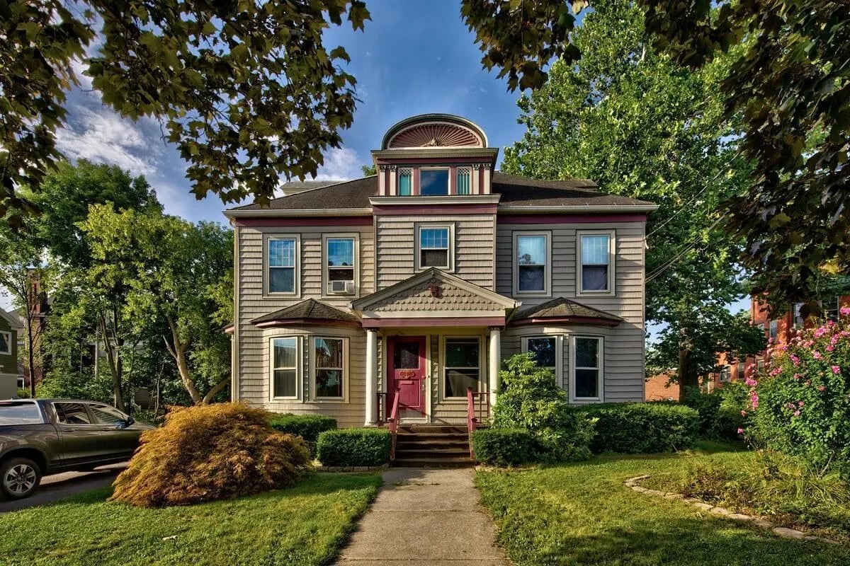 House with porch windows and landscaping exterior at Stonebridge Campus Living - Binghamton in Binghamton Student Accommodation