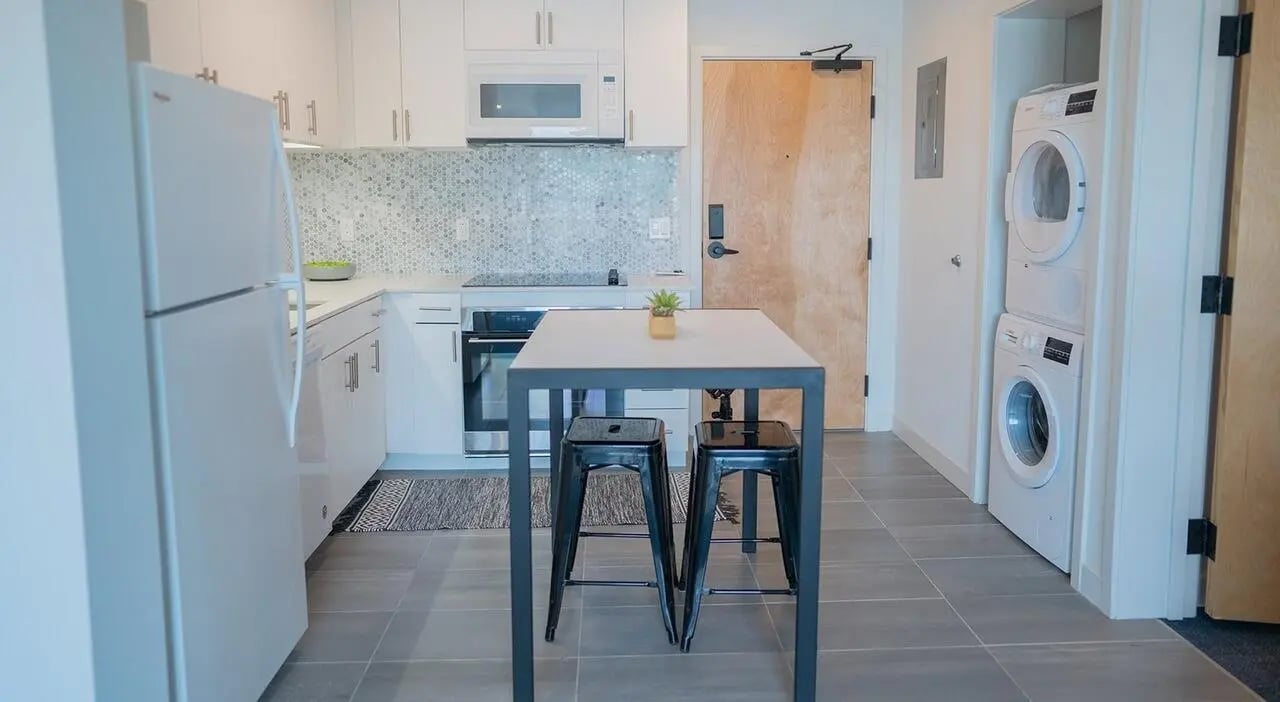 Kitchen with fridge stove table washer dryer Kitchen at Cheatham Street Flats in San Marcos Student Accommodation