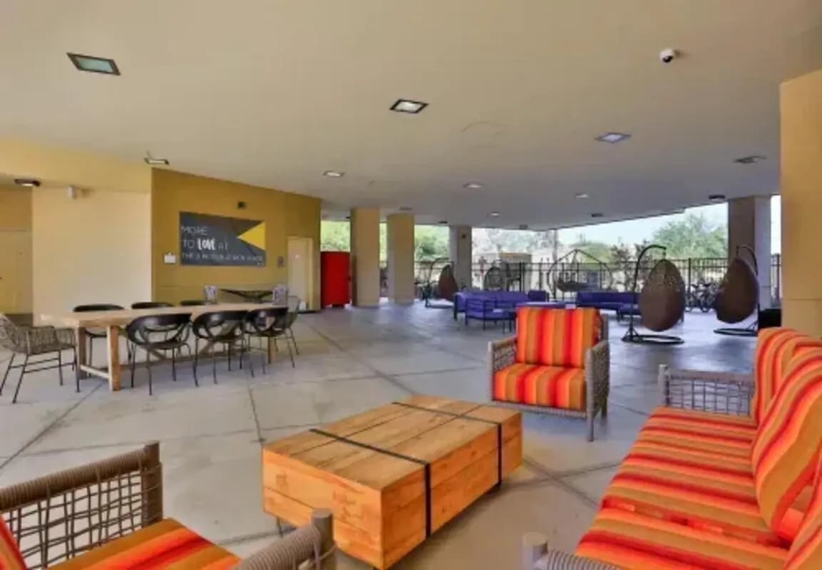 Lounge area with colorful seating and tables outdoor space at The Junction At Iron Horse Student Housing in Tucson Student Accommodation