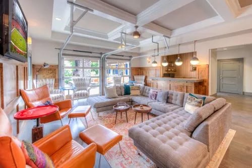 Large sectional sofa and orange chairs living room at The Reserve San Antonio in San Antonio Student Accommodation