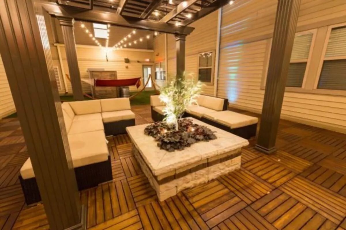 Outdoor seating area with sectional sofas and fire pit patio area at CollegePlace Uptown