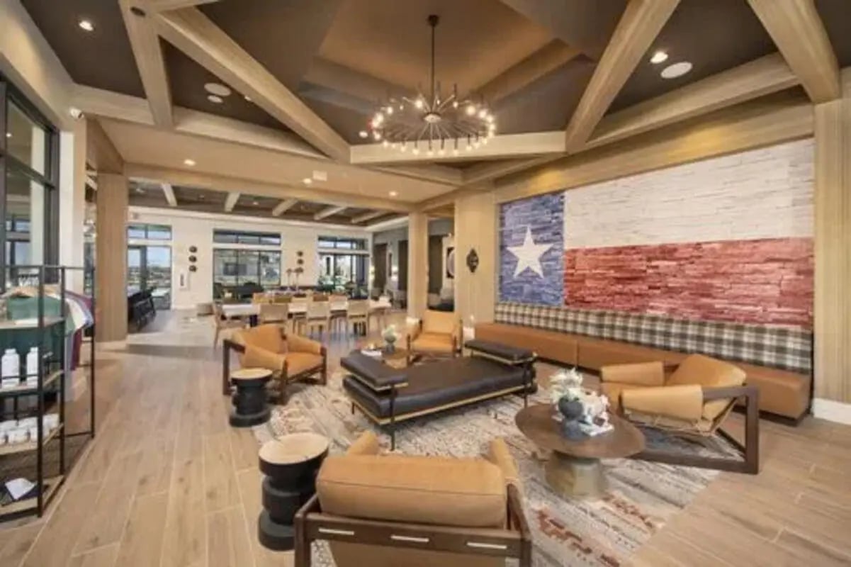 Texas flag mural leather sofas and chairs living area at The Wyatt in Lubbock Student Accommodation
