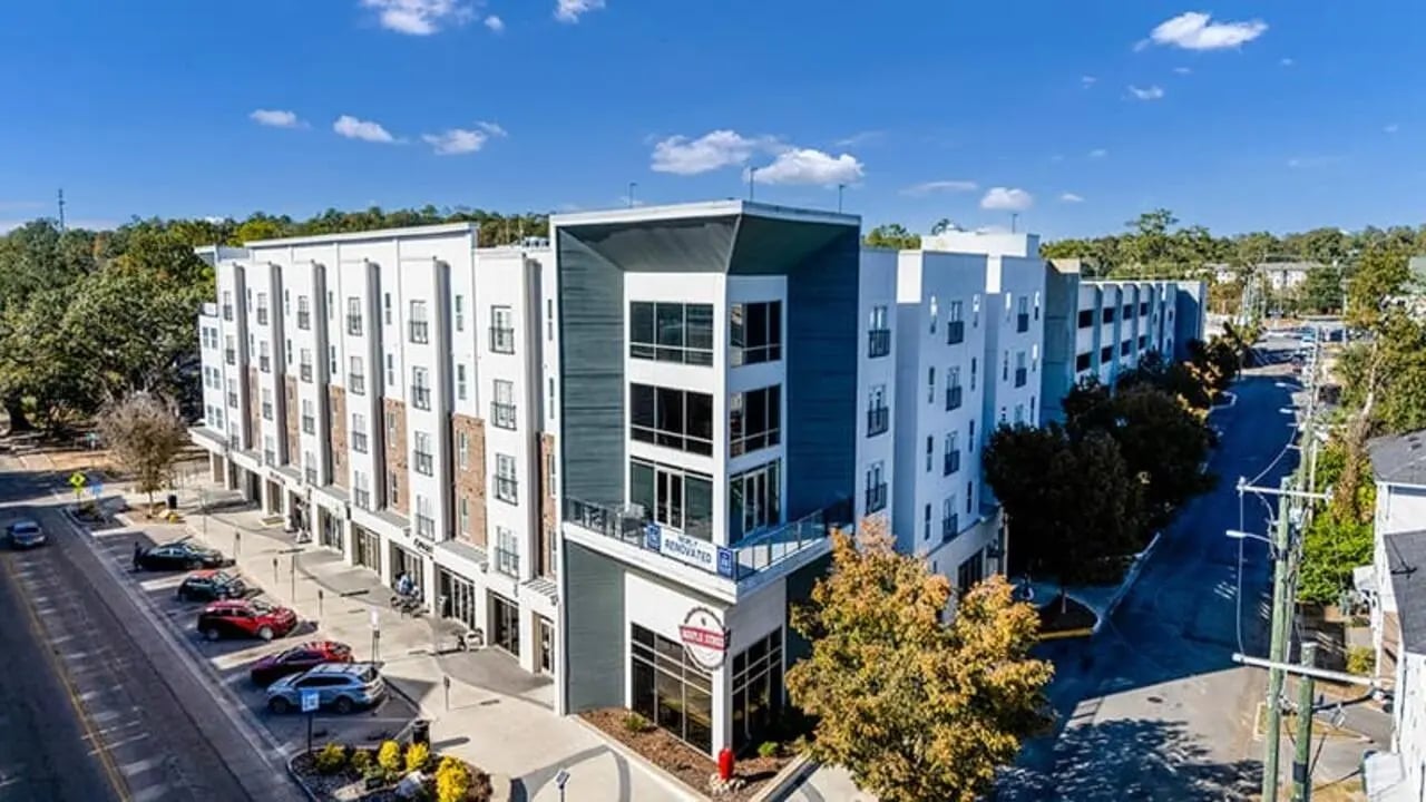 Modern white building with blue accents exterior at The Luxe on West Call in Tallahassee Student Accommodation