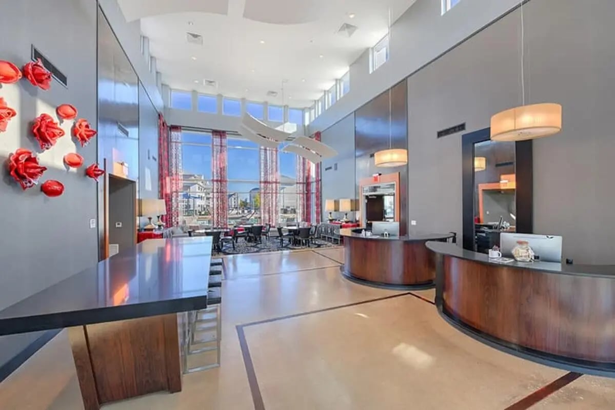 Modern lobby with reception desks and seating area Lobby interior at The Avenue at San Marcos in San Marcos Student Accommodation
