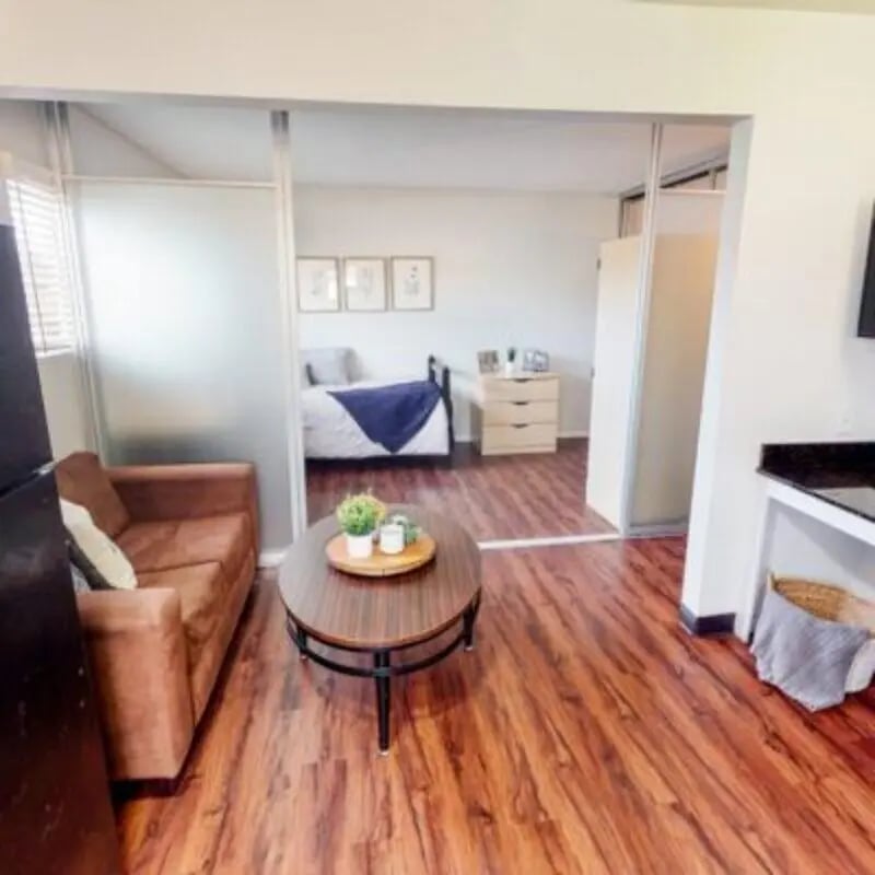 Sofa coffee table bed dresser artwork bedroom living room at Capri at Isla Vista Apartments in Isla Vista Student Accommodation