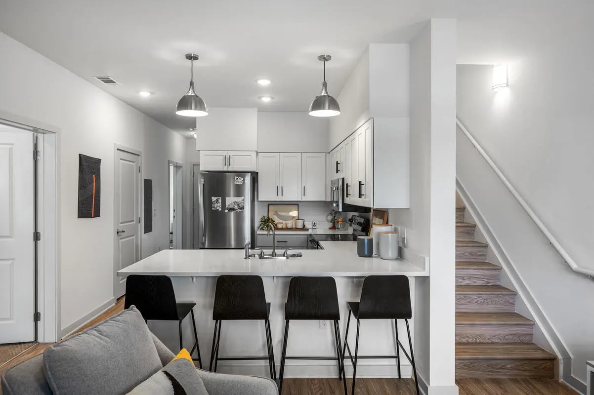 Modern kitchen with stainless steel appliances and bar stools kitchen at Aspen Heights University City in Charlotte Student Accommodation