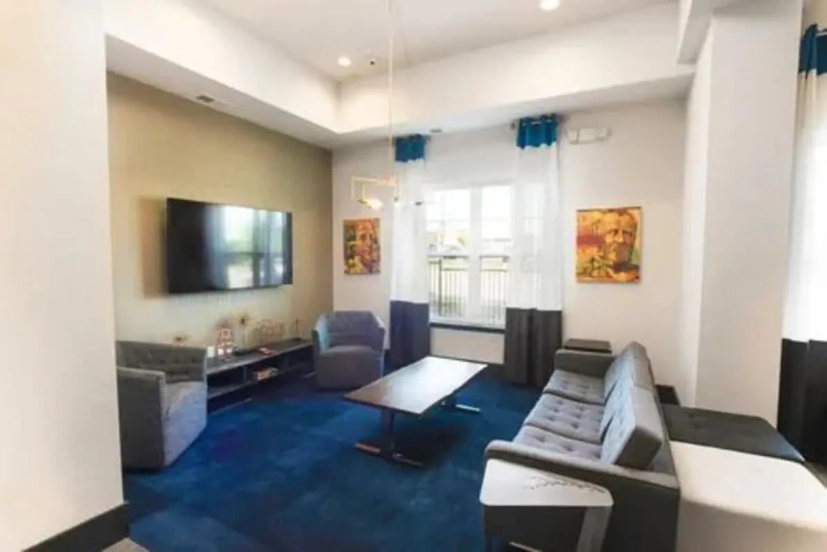 Sofa armchair television blue carpet communal area at Aspen Springfield in Springfield Student Accommodation