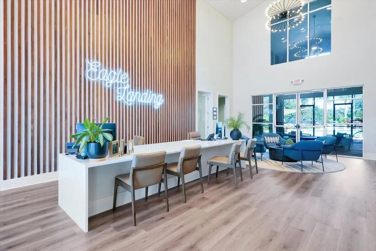 Reception desk with chairs and lounge seating lobby at Eagle Landing in Daytona Beach Student Accommodation