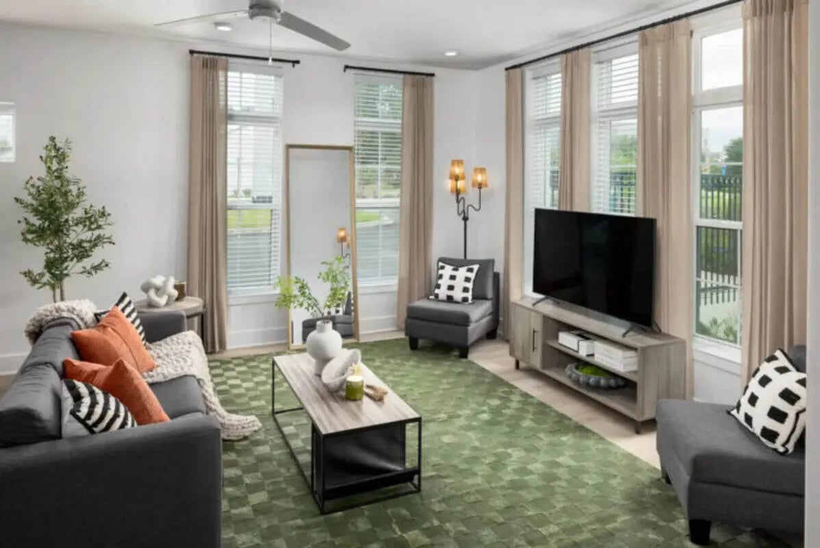 Modern living room with sofa TV and green rug living room at Prospect Row in Tallahassee Student Accommodation