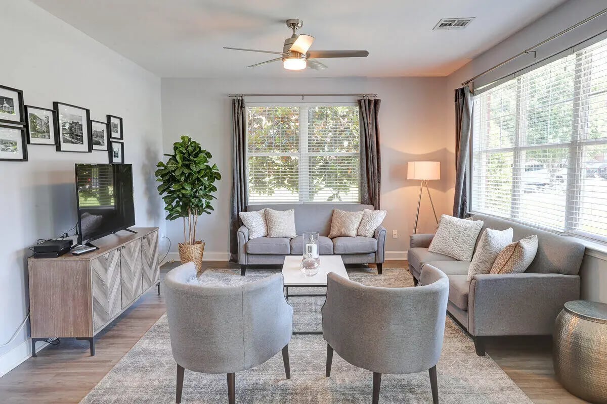 Two sofas chairs coffee table TV living room at Eagles Landing Apartments in Cookeville Student Accommodation