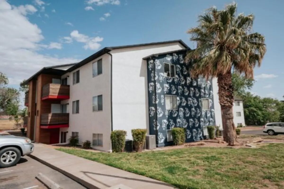 Apartment building balconies and palm tree exterior at Cedar Flats Student Housing in St. George Student Accommodation