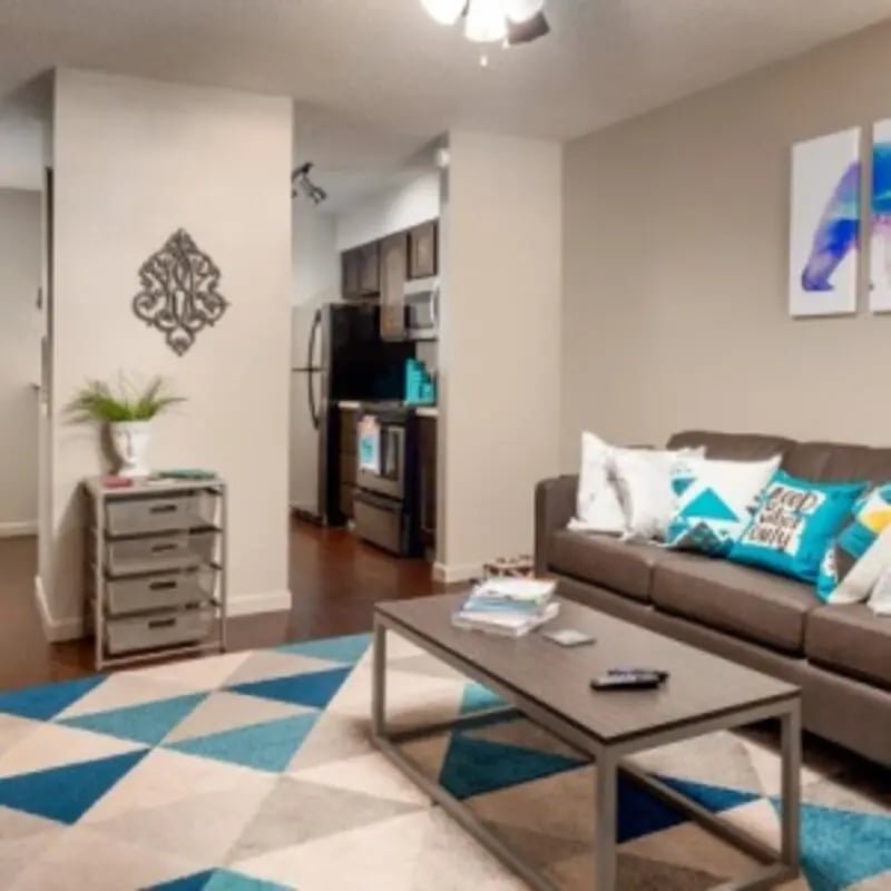 Brown sofa coffee table kitchen living room at Eastgate Apartments in Waco Student Accommodation