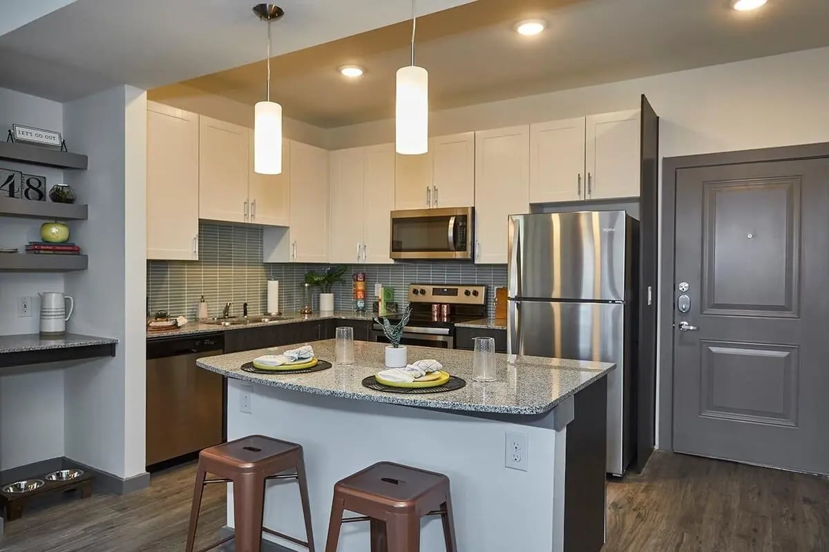 Kitchen island with stools refrigerator appliances door kitchen at 848 Mitchell in Arlington Student Accommodation