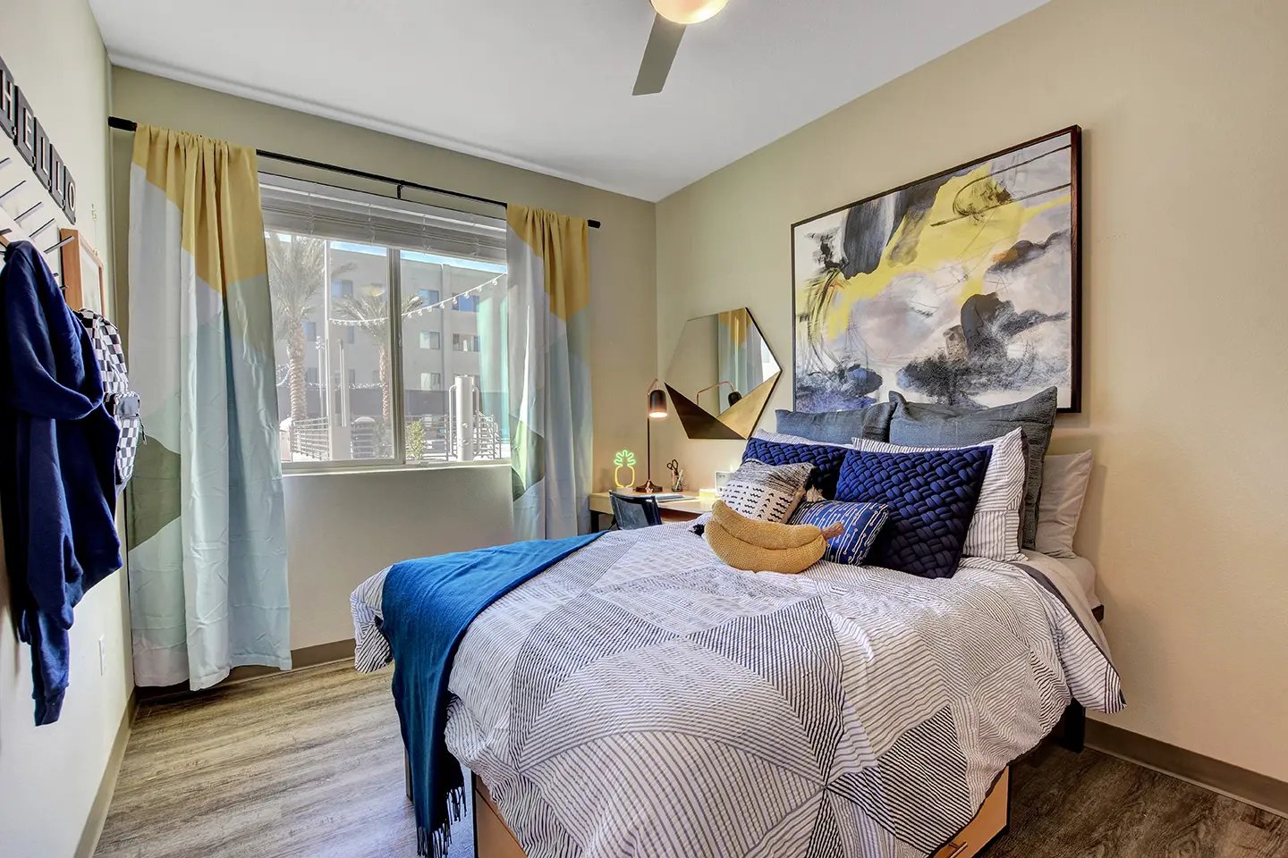 Bed desk lamp mirror abstract art bedroom at Echo 1055 Apartments in Las Vegas Student Accommodation