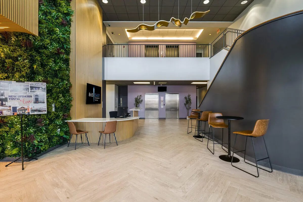Reception desk plants and seating area interior at 865 East in Harrisonburg Student Accommodation