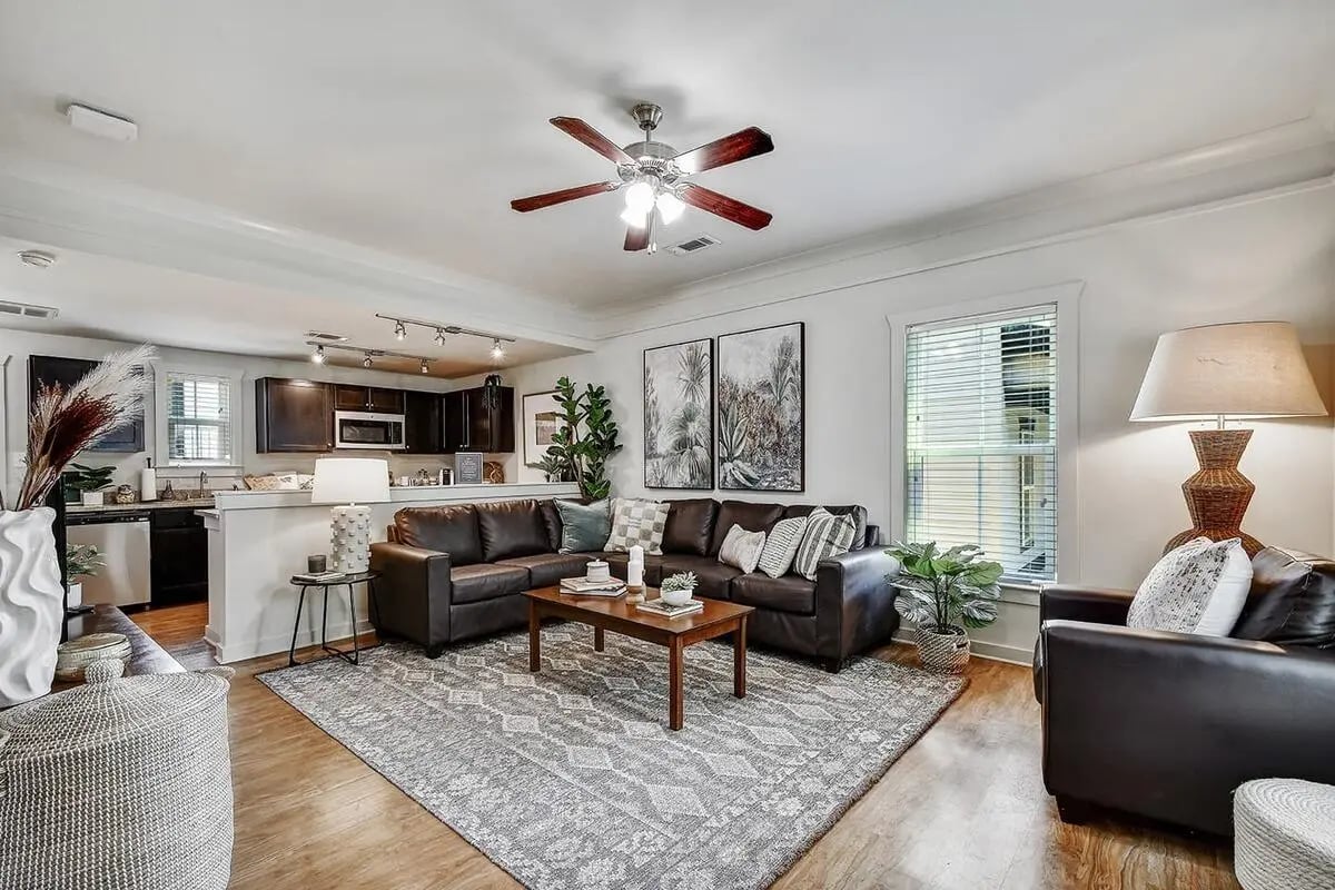 Brown sectional sofa coffee table kitchen living room at Cottages at San Marcos in San Marcos Student Accommodation