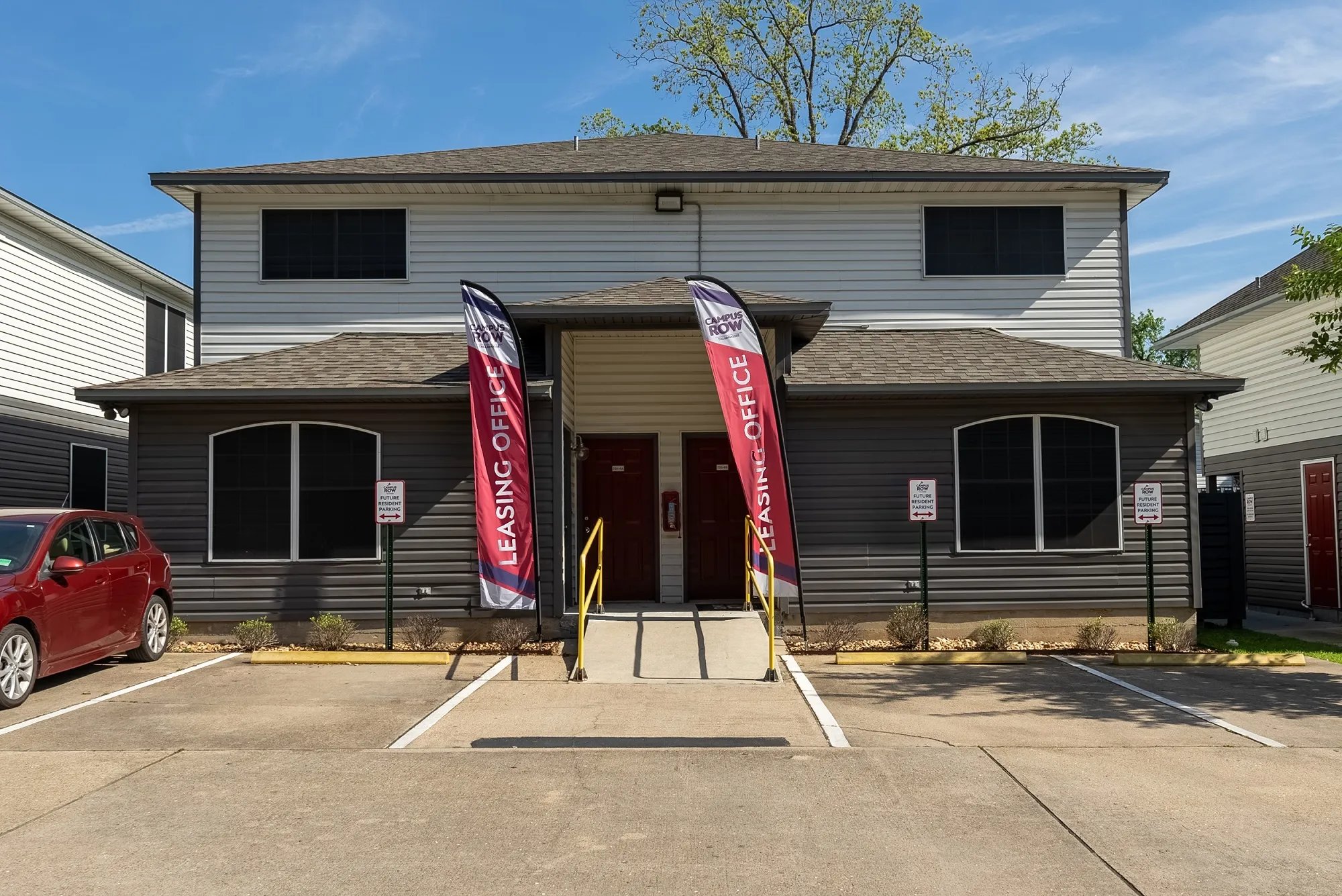 Apartment building with two leasing office banners exterior at Campus Row in Tallahassee Student Accommodation