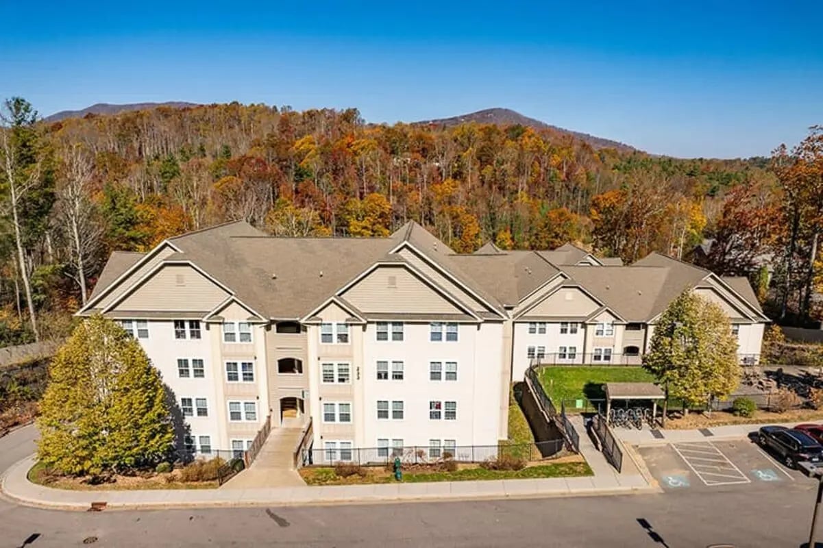 Apartment building with trees and mountains exterior at Boone Student Living in Boone Student Accommodation