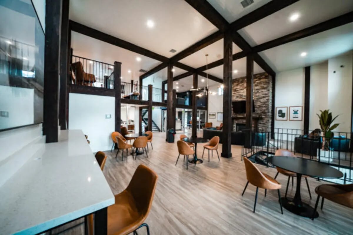 Modern common area with tables and chairs living room at Glenwood Apartments in Provo Student Accommodation