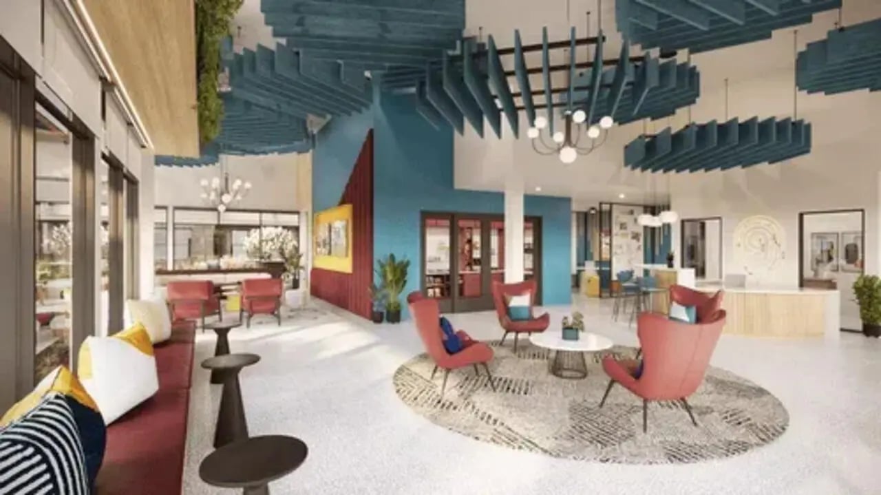 Lounge area with red chairs and sofa communal space at Global College Station in College Station Student Accommodation