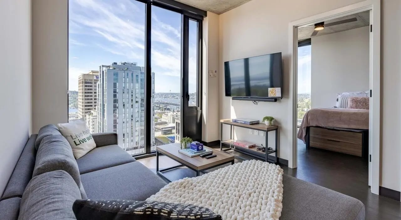 Gray couch coffee table and bed living room at The M Seattle in Seattle Student Accommodation