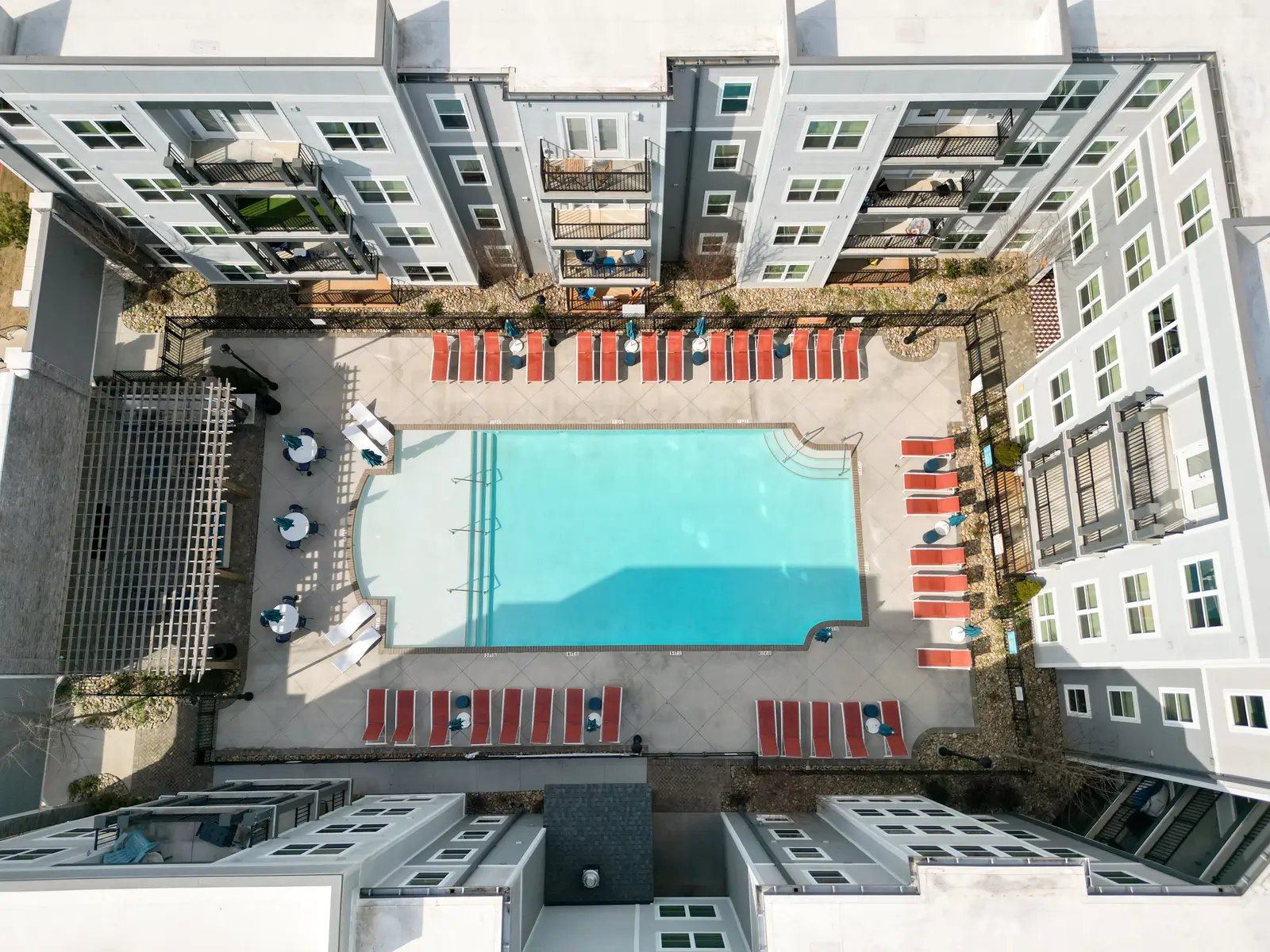 Apartment complex courtyard pool with lounge chairs exterior at Dockside Clemson in Clemson Student Accommodation