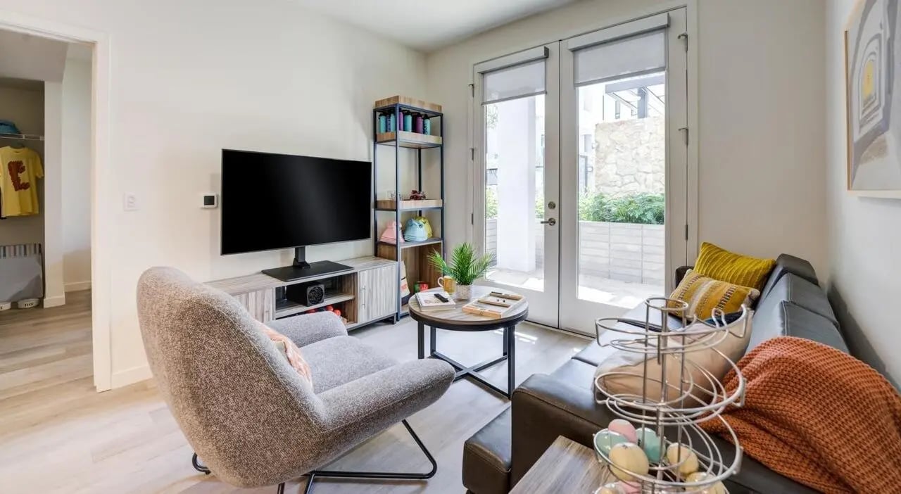 Living room with gray chair and couch living room at Union Grantville in San Diego Student Accommodation