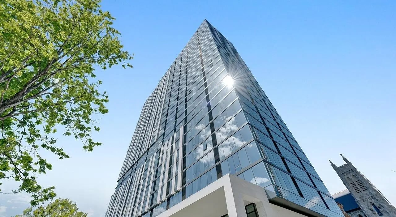 Glass skyscraper with trees and church exterior at The Chestnut in Philadelphia Student Accommodation