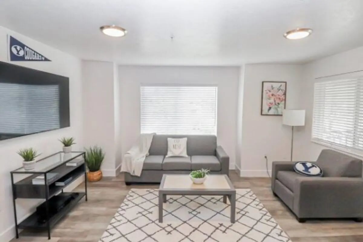Gray couches coffee table television living room at Fleur De Lis Apartments in Provo Student Accommodation