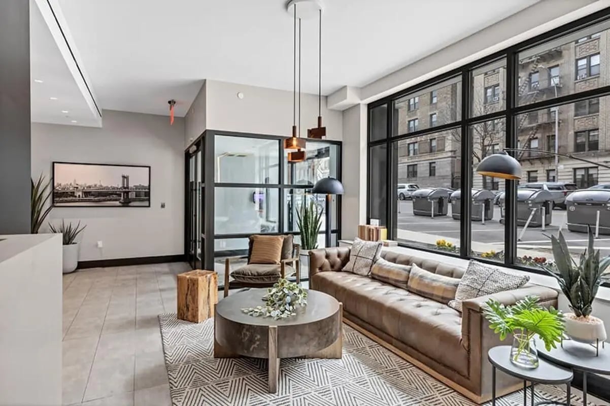 Brown sofa, coffee table, chair, living room at Monarch Heights Apartments