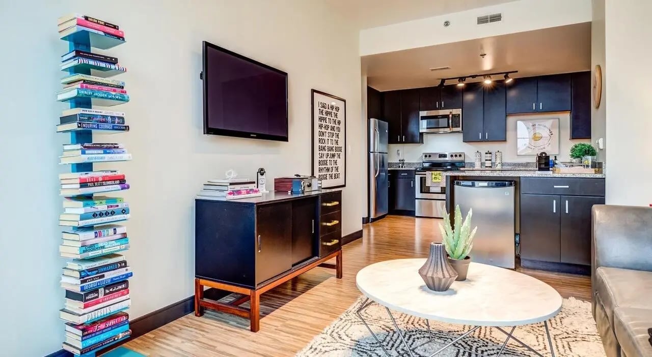 Bookshelf television cabinet and kitchen living area at Landmark Apartments in Ann Arbor Student Accommodation