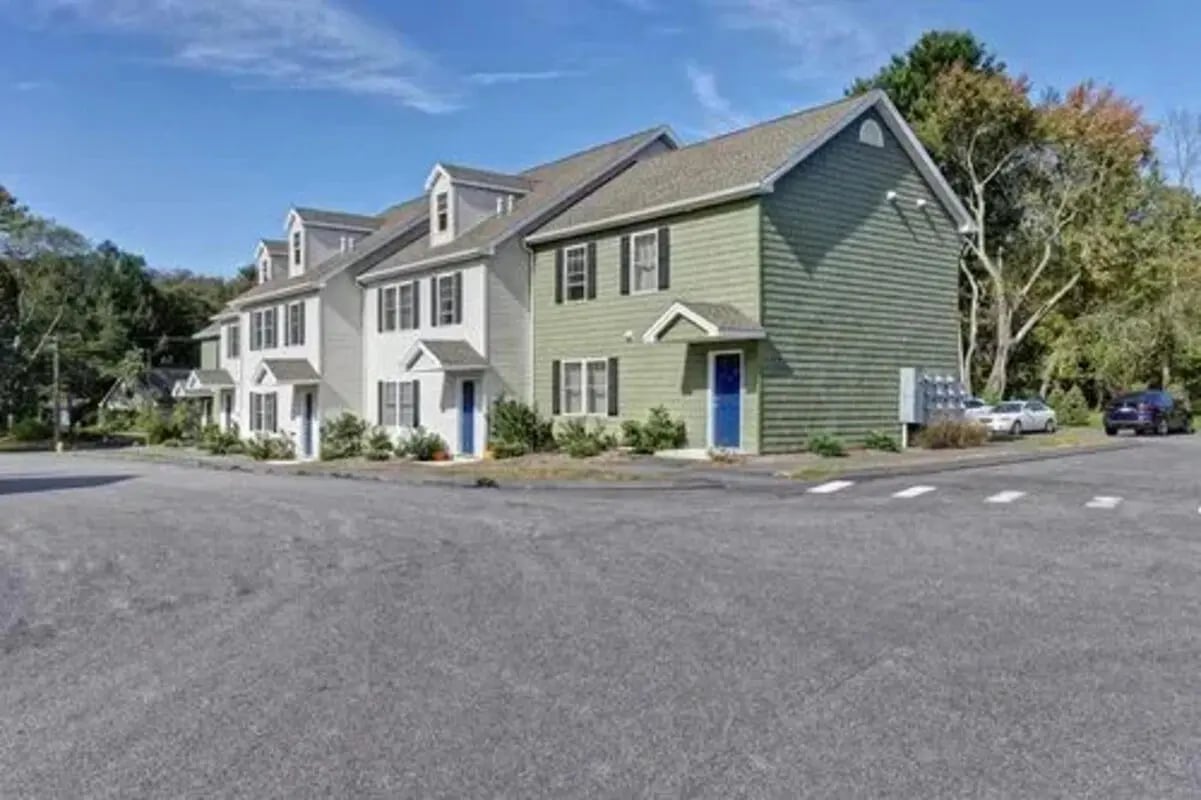 Townhouses with green and white exteriors exterior at Meadowbrook Gardens