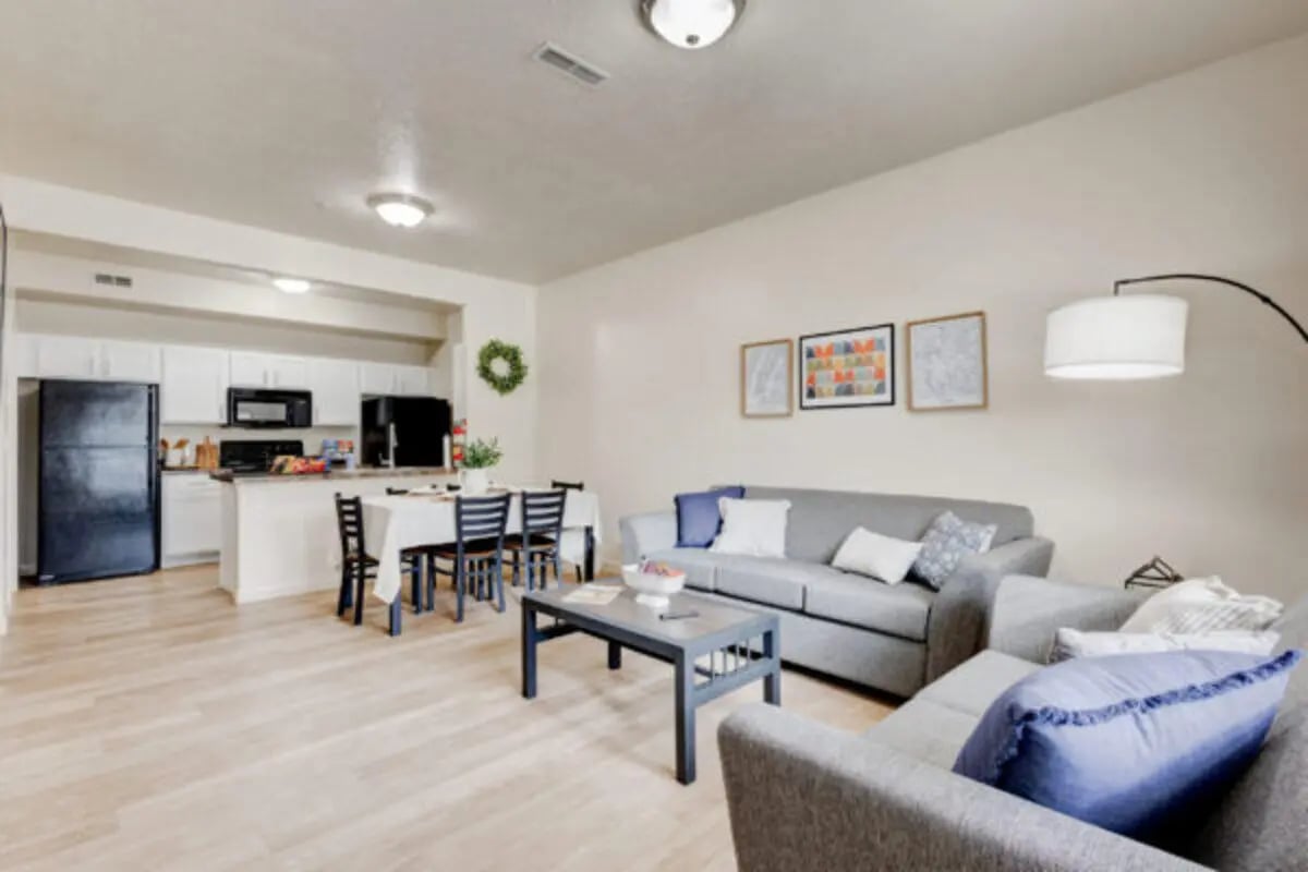 Sofa table kitchen and dining area living room at The Gates in Rexburg Student Accommodation