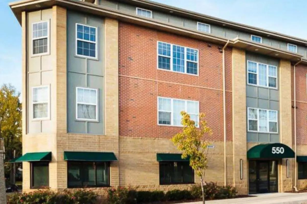 Modern student housing building with brick and tan exterior exterior at The Gates in East Lansing Student Accommodation