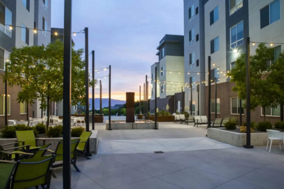 Courtyard with chairs tables lighting exterior at The Green on Campus Drive - Building 4 in Orem Student Accommodation