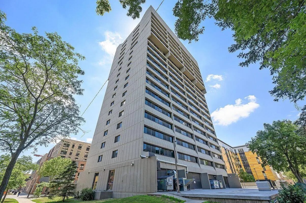 Tall apartment building with windows and trees exterior at Chateau Student Housing Co-op in Minneapolis Student Accommodation