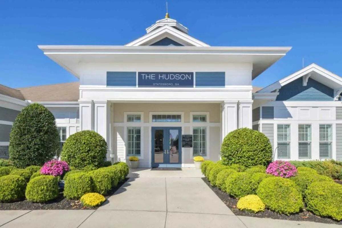 The Hudson signage double blue doors lush bushes exterior at The Hudson in Statesboro Student Accommodation