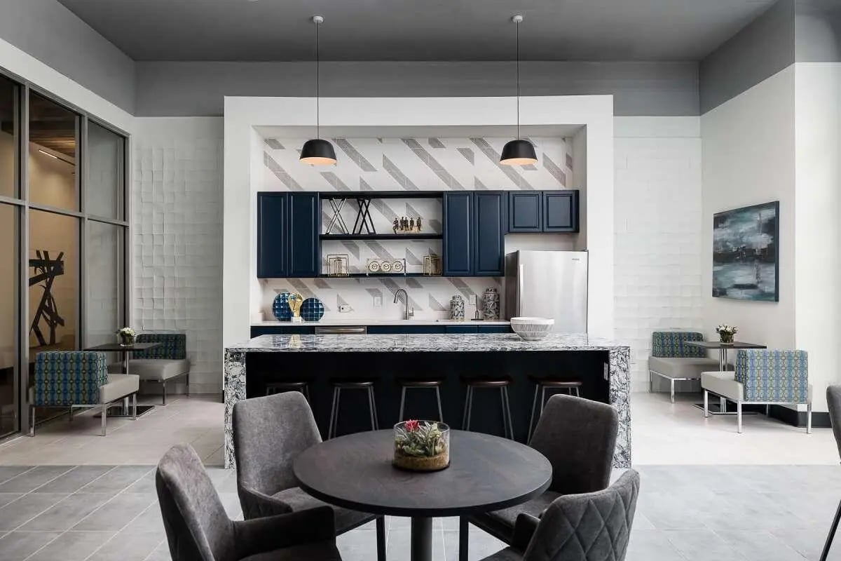 Island kitchen with seating and tables common area at The Lex in Lexington Student Accommodation