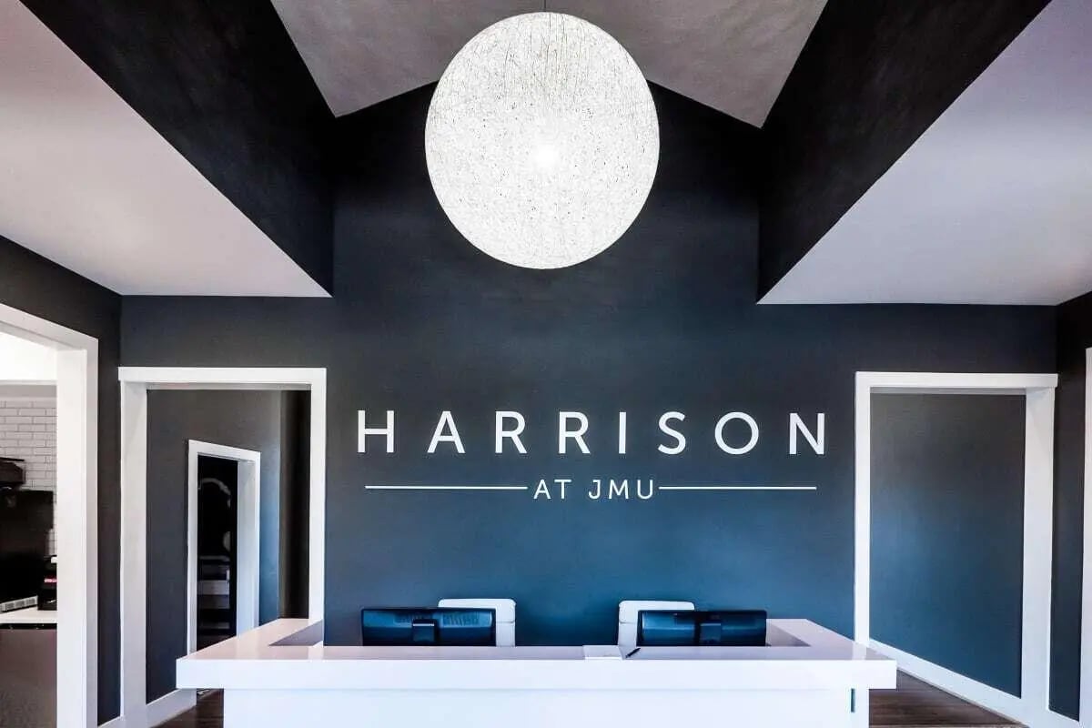 White reception desk with computers lobby at The Harrison in Harrisonburg Student Accommodation