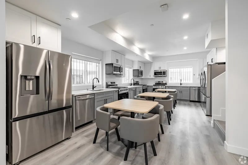 Stainless steel fridge tables chairs kitchen at 1476 W 35th St in Los Angeles Student Accommodation