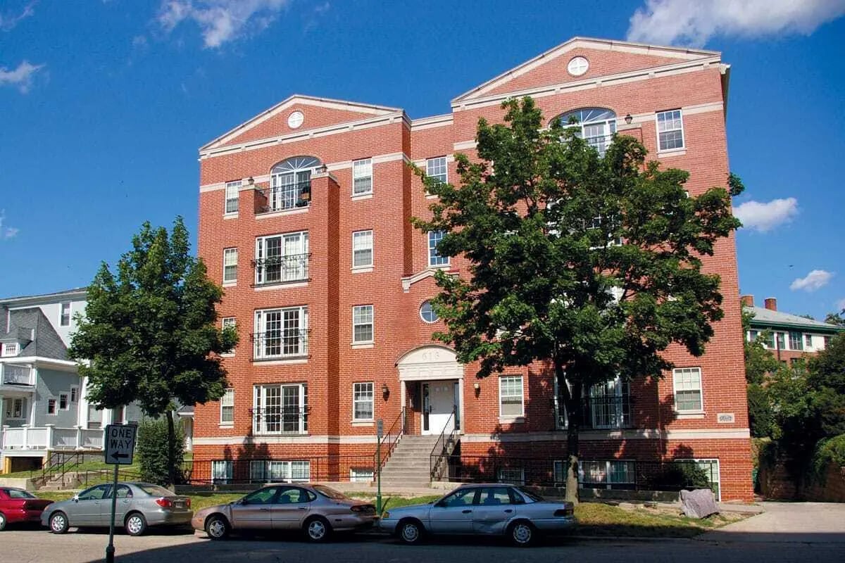 Brick student housing with trees and cars exterior at 625 on Langdon in Madison Student Accommodation