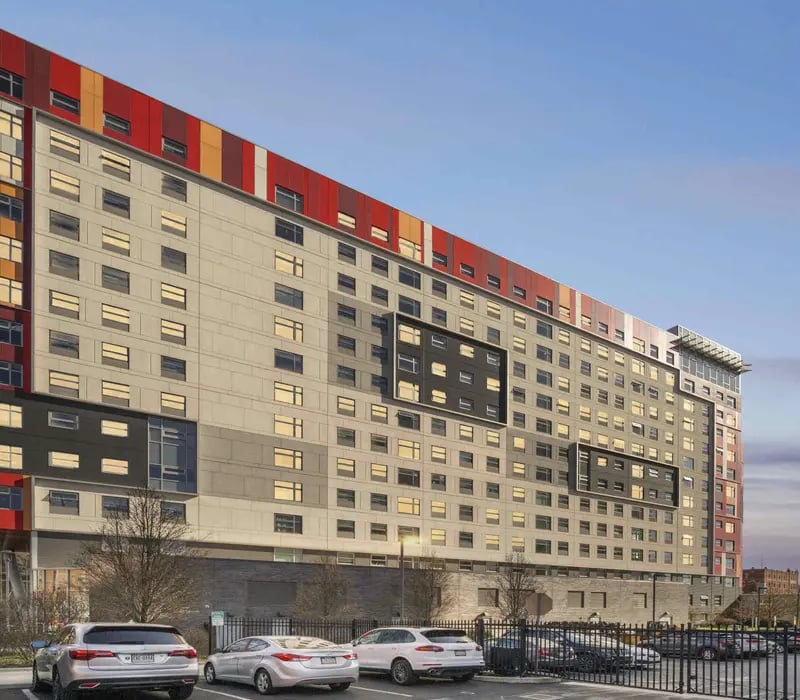 Modern student housing building with red accents exterior at The View at Montgomery in Philadelphia Student Accommodation